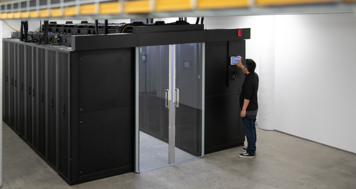 Man typing on a control panel in MyHost's datacentre.